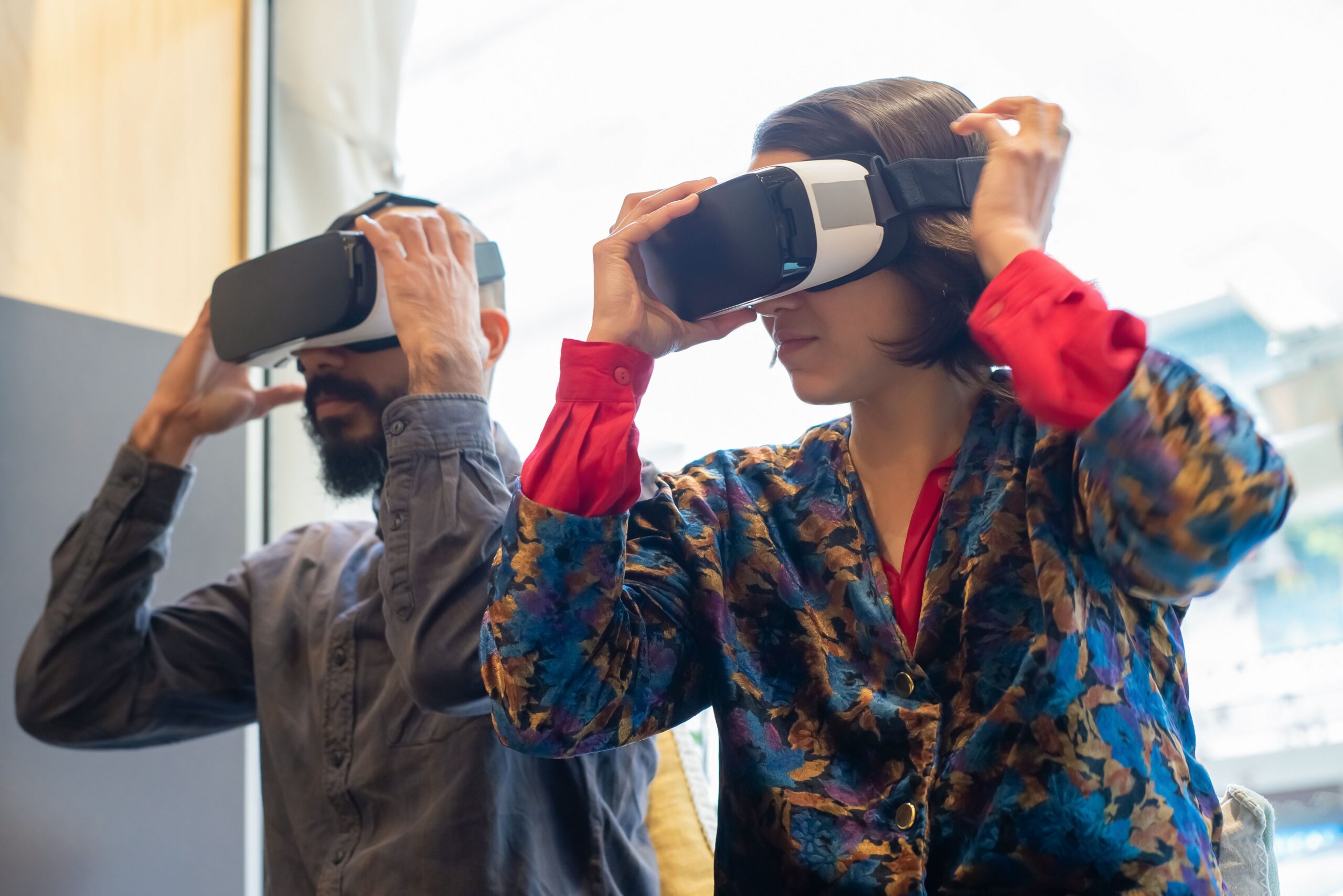 Dwie osoby zakładają gogle VR podczas spotkania dla opiekunów rodzinnych